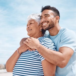 Shot of a young man spending the day at the beach with his elderly mother.